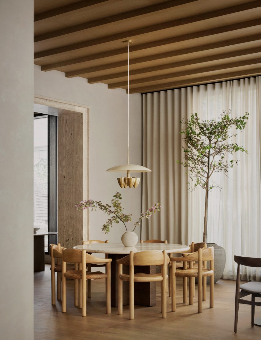 Circular table with wooden chairs and pendant light 
