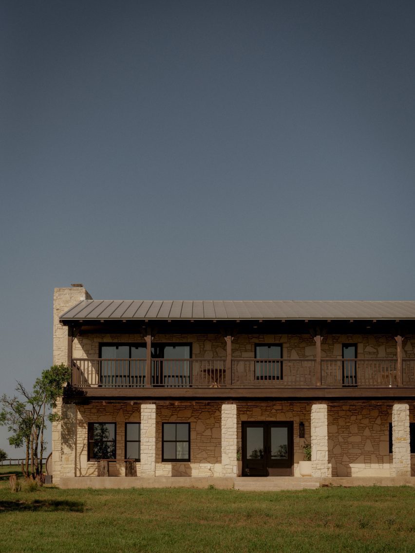 Exterior of two-storey ranch style house with stone cladding