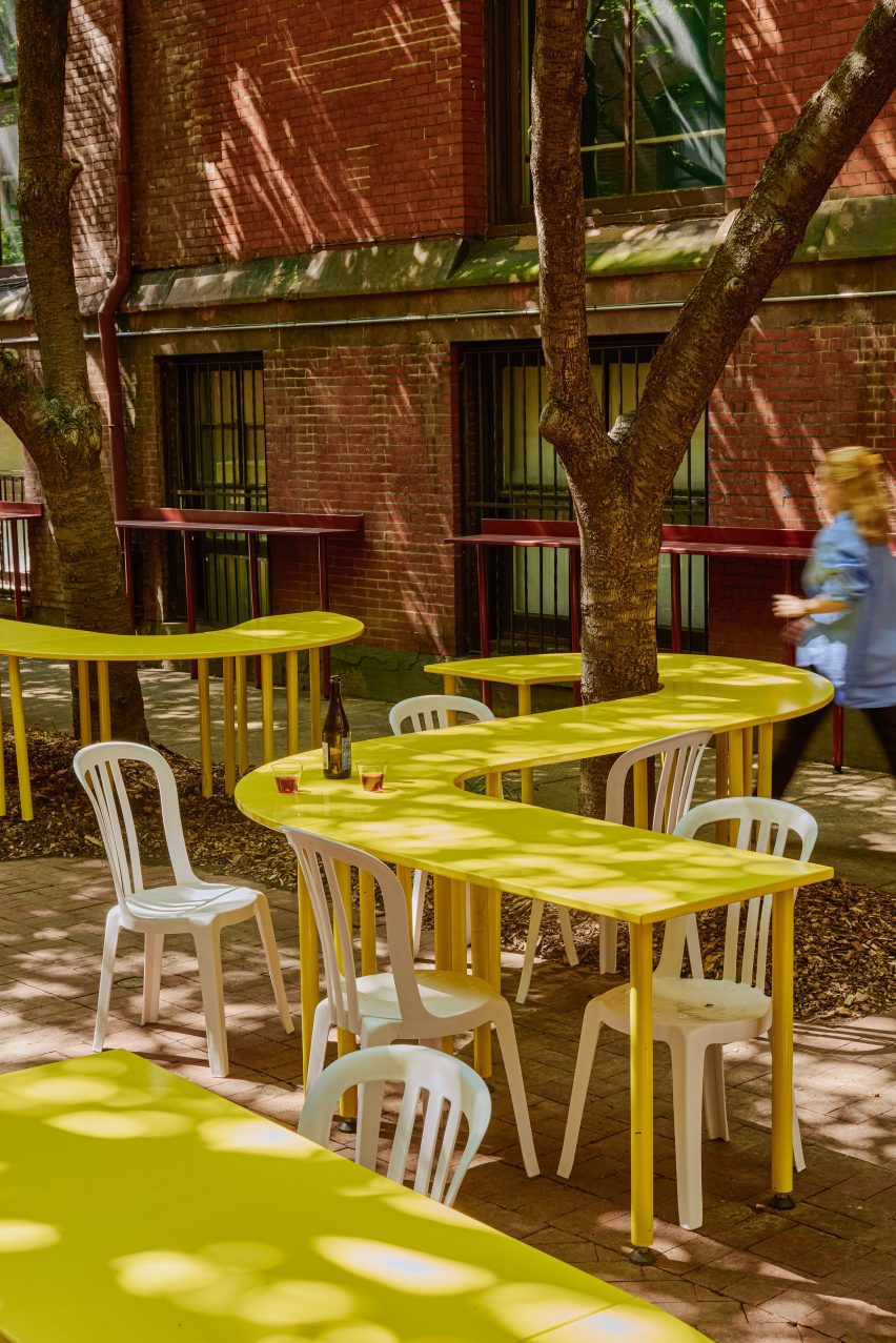 Winding yellow tables in brick alley