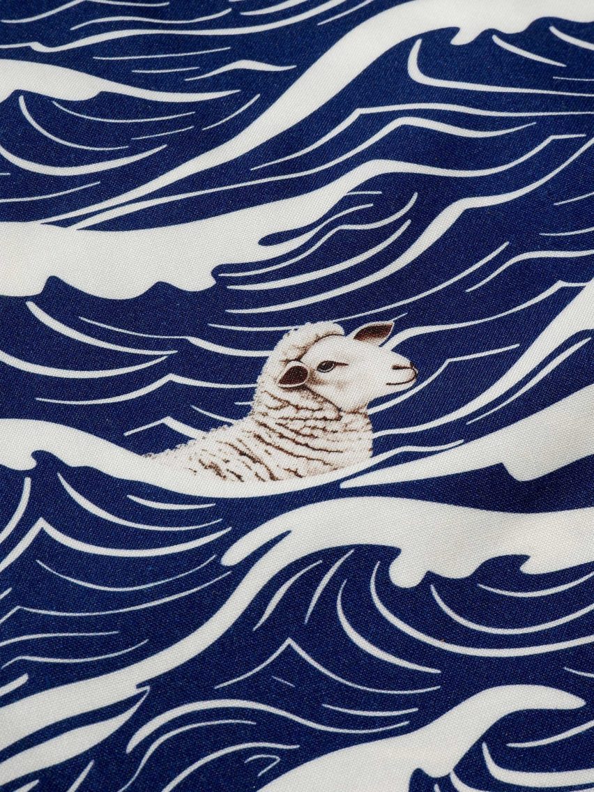 Close-up of textile showing a sheep swimming