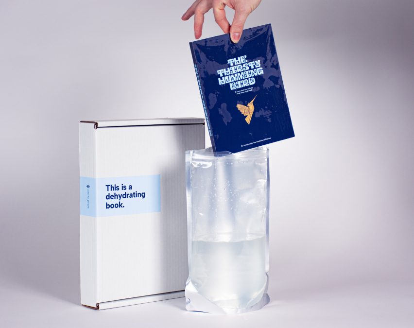 A wet book being lifted out of a bag filled with water