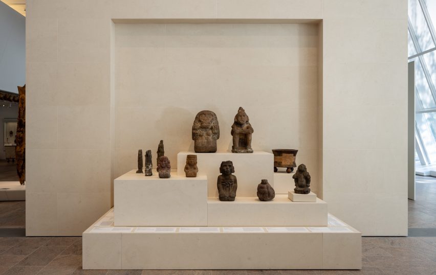 Stone sculptures from the ancient Americas displayed on stepped plinths