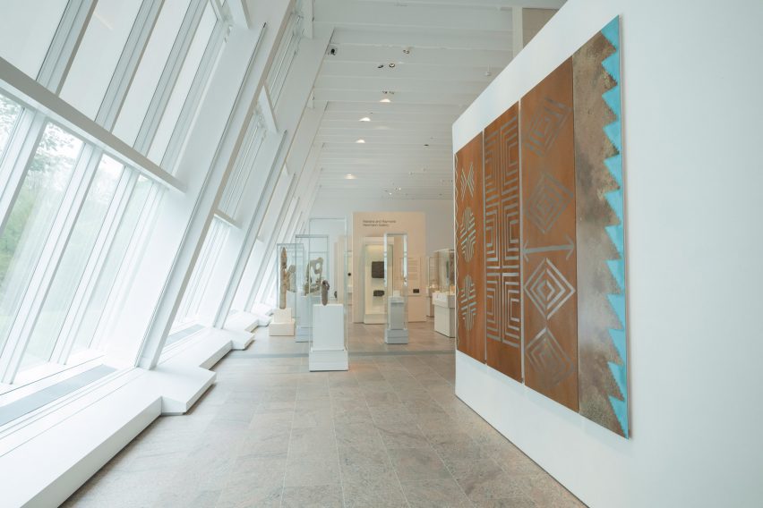 Row of large slanted windows along a gallery