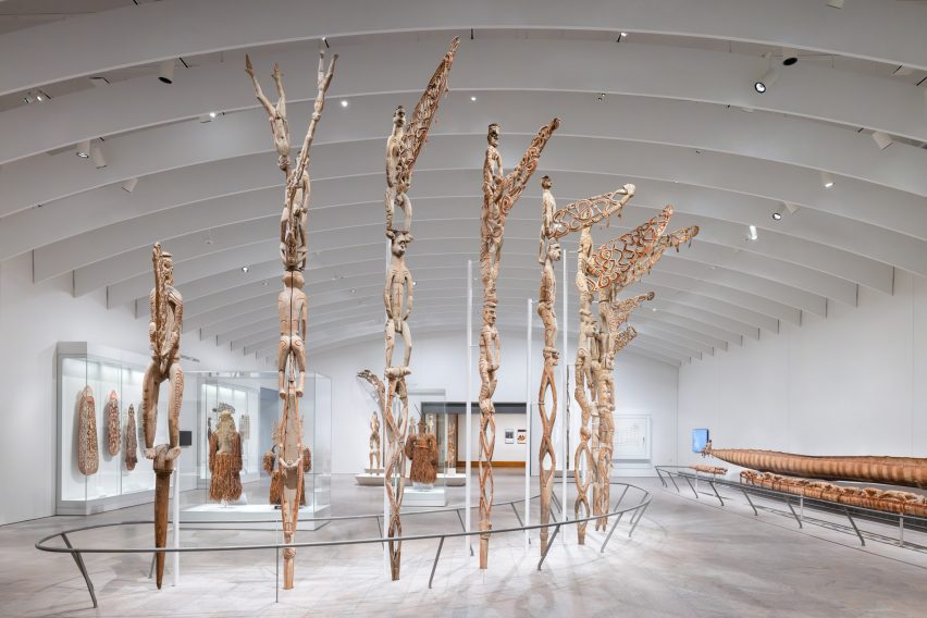 Oceanic sculptures below tall white-ribbed ceiling