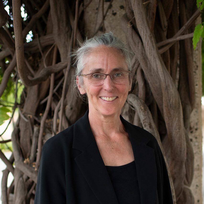 a photograph of a person in front of a tree