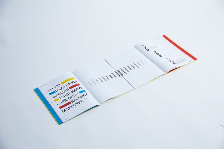 a photograph of an open book with white pages and text in tones of blue, yellow, red and black