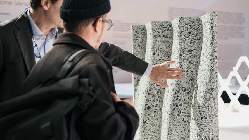 People looking at stone carving at Marmomac