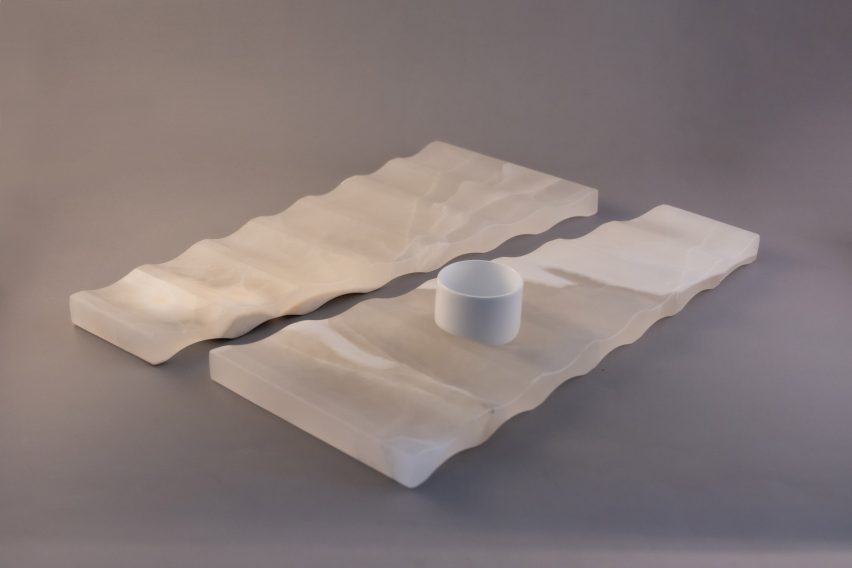 a white rectangular abstract object displayed against a grey backdrop