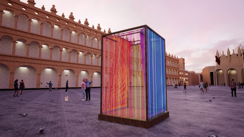 a photograph of an installation in the shape of a cube, with threads running through it in tones of blue and red