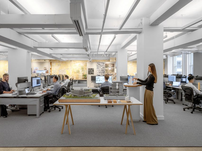Open-plan office space with architectural models in the centre