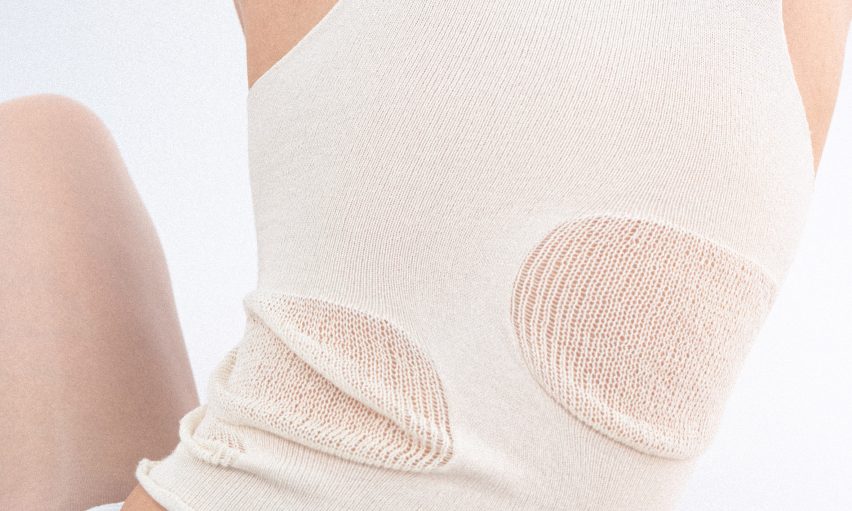 a cropped photograph of a person wearing a white knitted garment