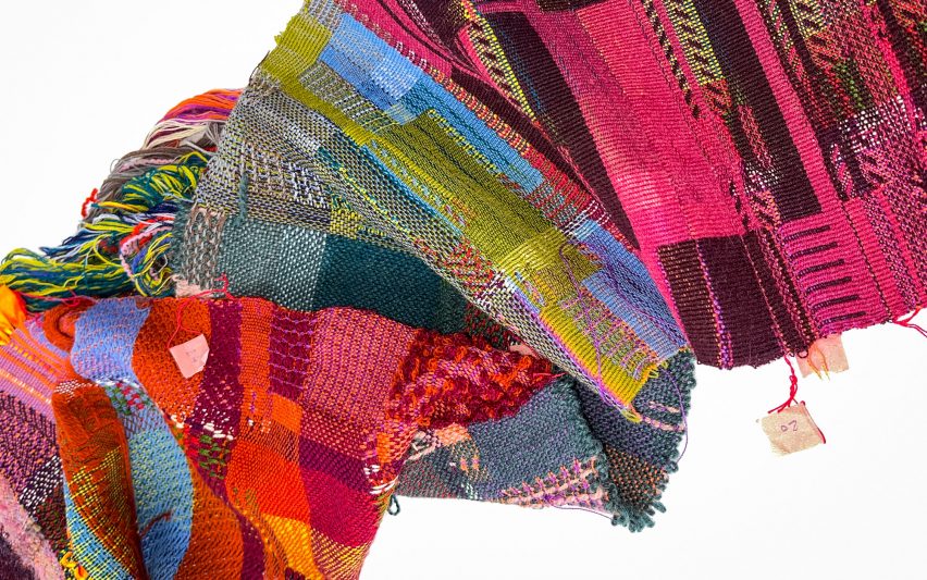 a photograph of textiles in tones of pink, green and red