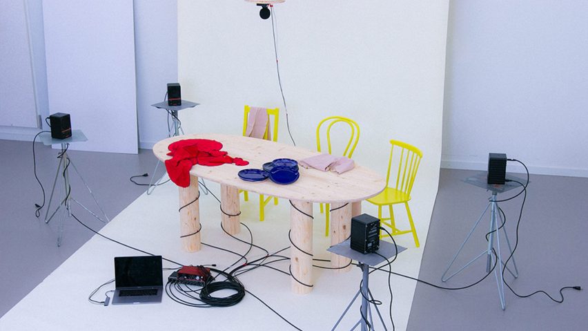 a photograph of a table and chairs with wires around them