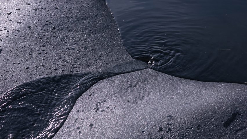 a photograph of water flowing off a rock