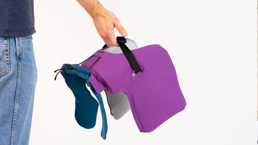 a photograph of a person's hand holding an object in tones of purple and blue