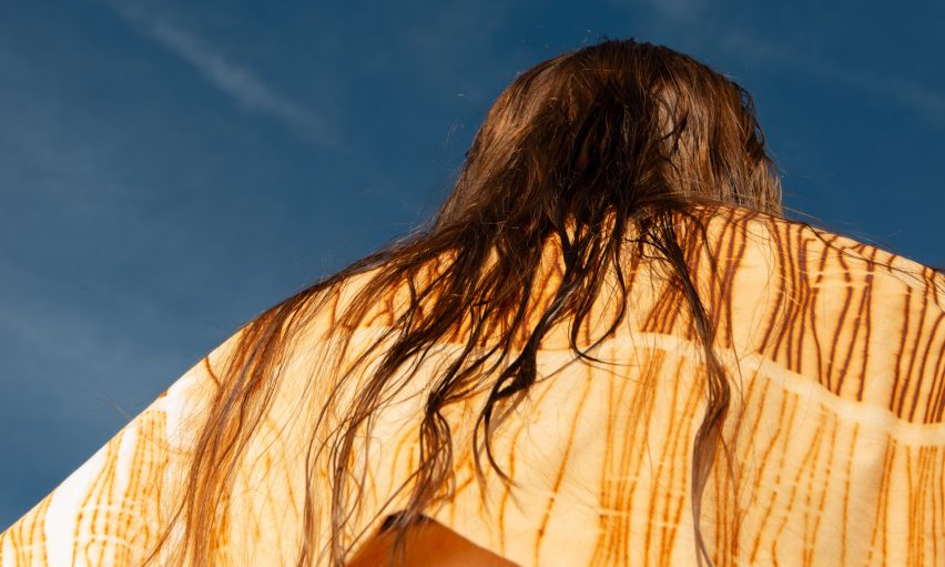 a photograph of a person wearing a yellow garment