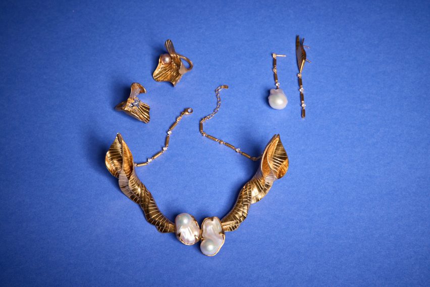 a photograph of jewellery laid against a blue surface