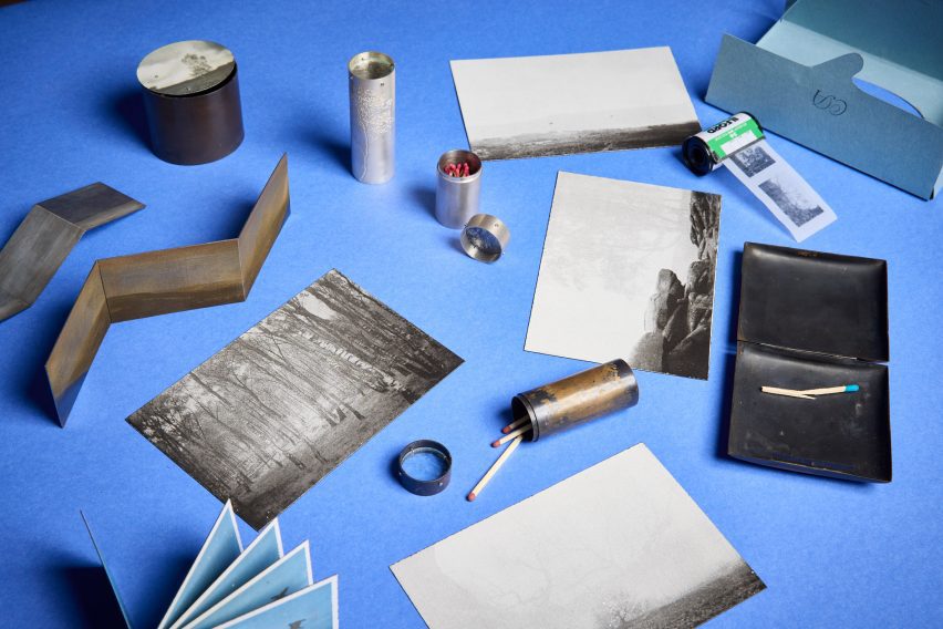 a photograph of printed images and matchsticks laid out on a blue backdrop