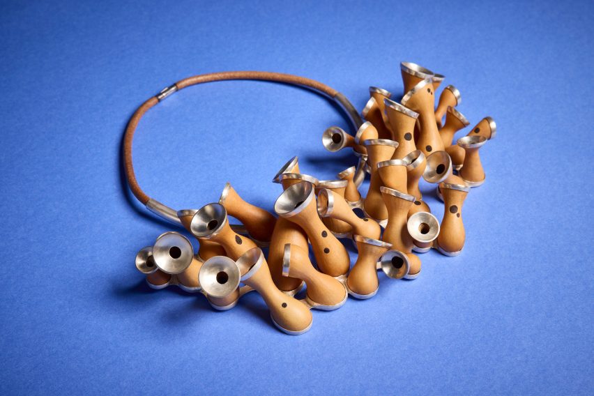 a photograph of an abstract object, in tones of brown and silver against a blue surface