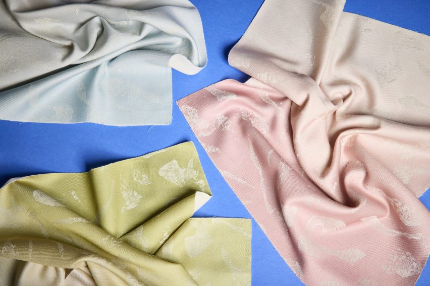 a photograph of pink, green and grey fabrics placed against a blue backdrop 