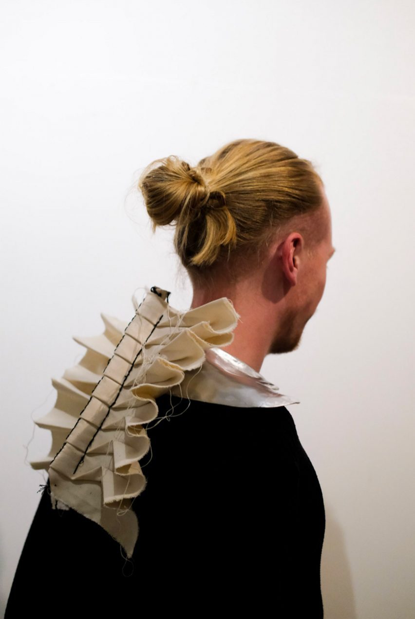 a photograph of a person wearing a beige garment on their back