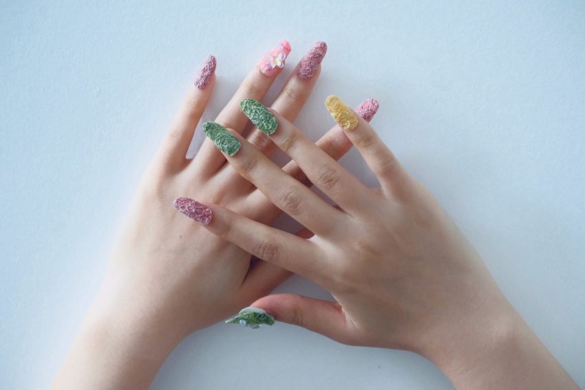 a photograph of a person's hands wearing biodegradable press on nails