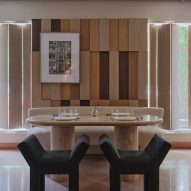 Marble table with green chairs in front