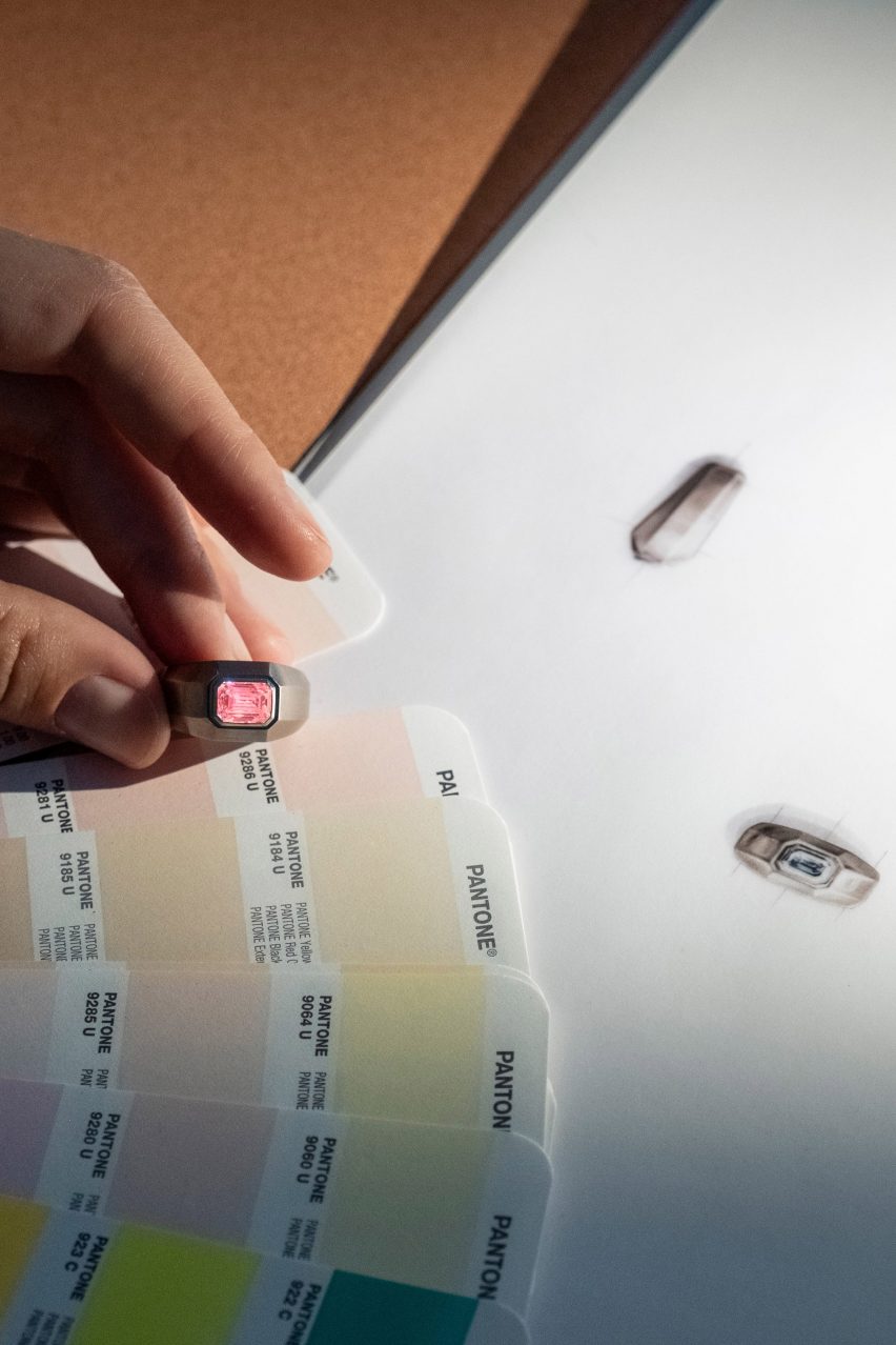 Hand holding a ring up to a colour chart