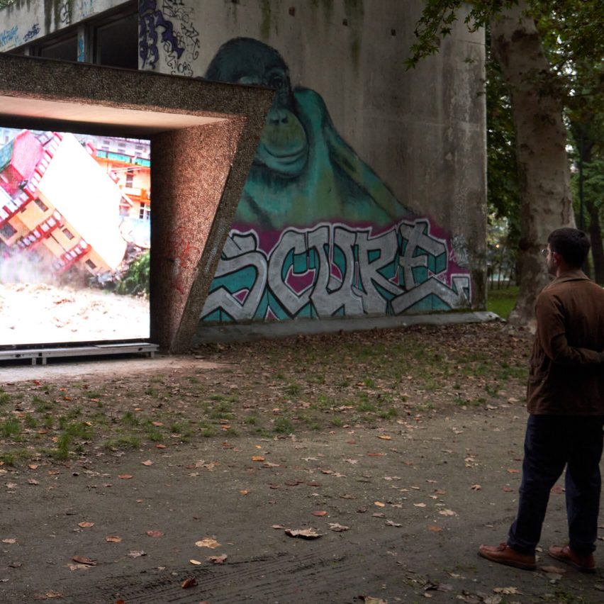a photograph of a person looking at a screen in a park