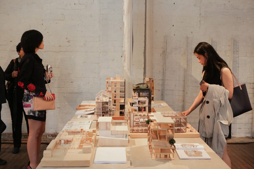 a photograph of people interacting with an exhibition