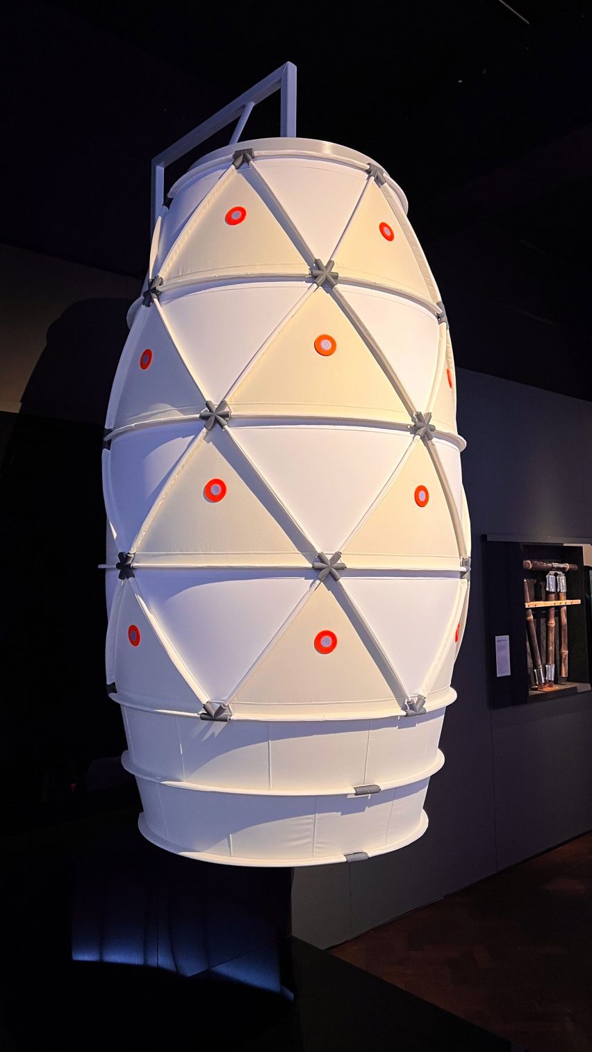 a photograph of an oval-shaped model in tones of white and orange