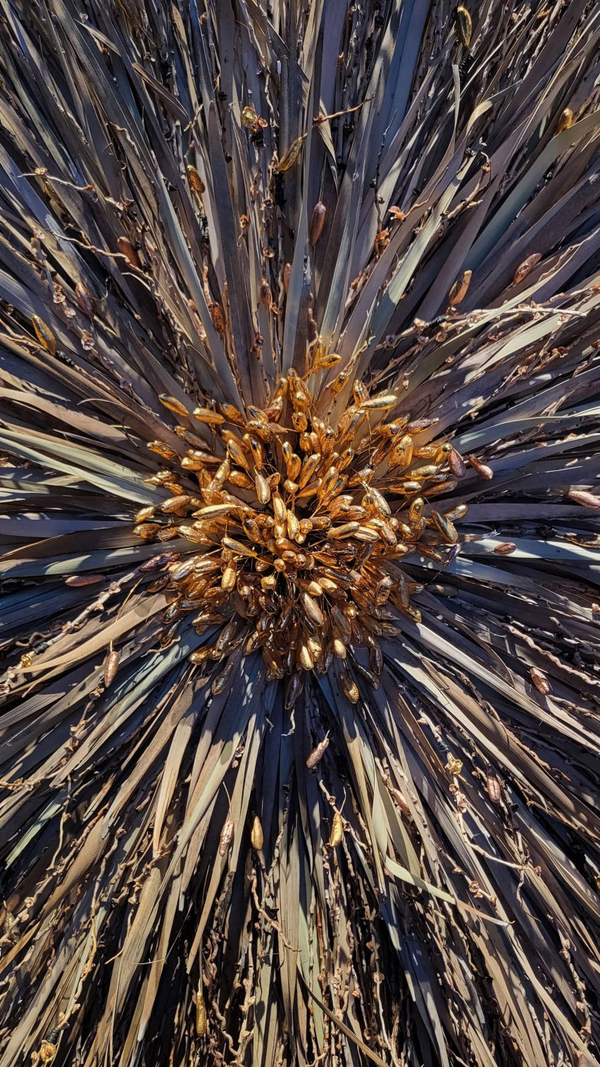 a cropped photograph of an abstract structure in tones of beige, brown and grey