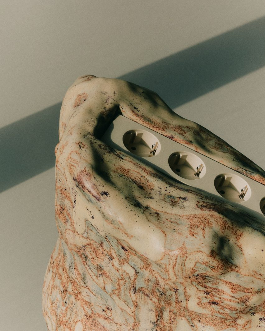 Close-up of ceramic sculpture with plugs at the centre