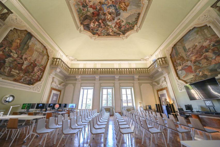 Rows of chairs in a lofty room