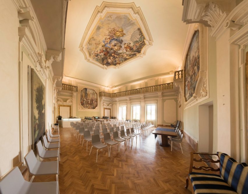 Room with high ceilings and rows of chairs