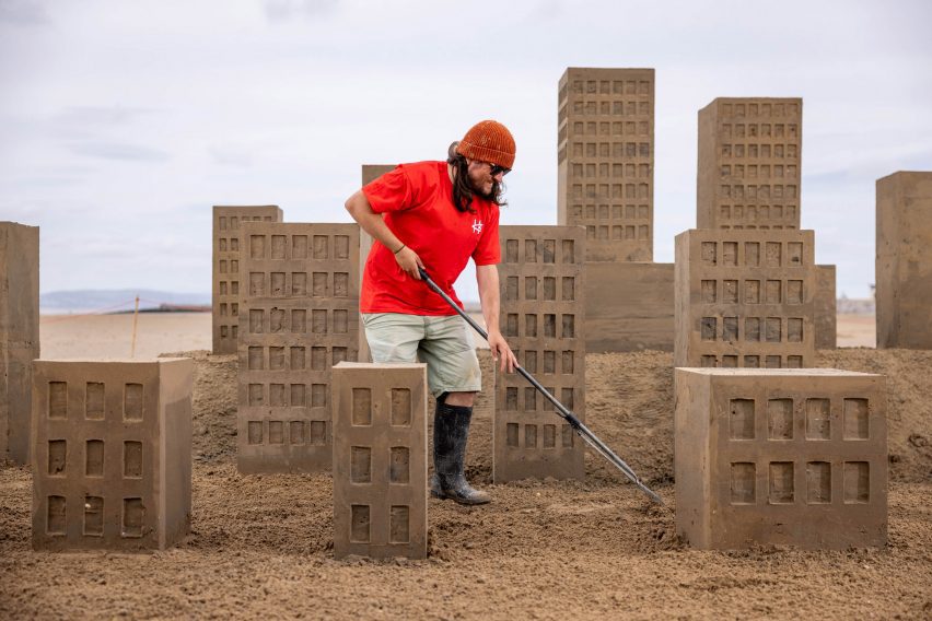 Man on beach with sand castles