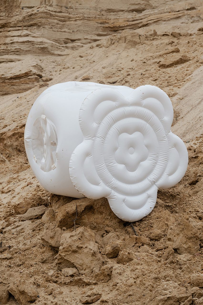 a photograph of an inflatable white object on sand