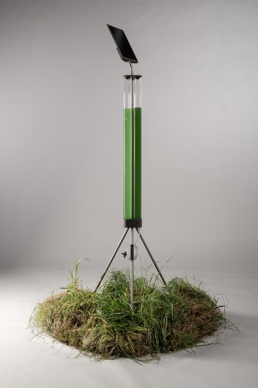 a photograph of an object in a tripod-like structure, on a patch of grass