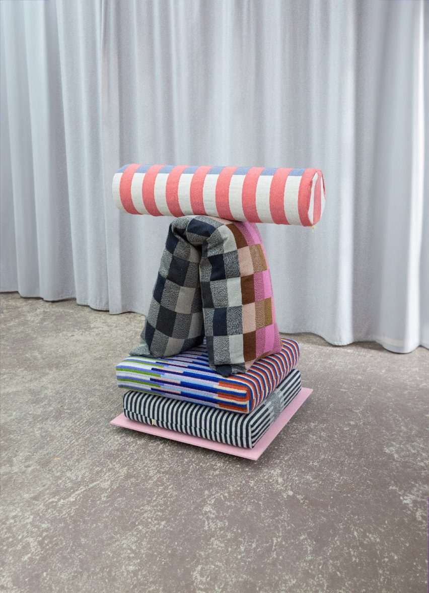 a photograph of cushions in tones of blue, grey, pink and white