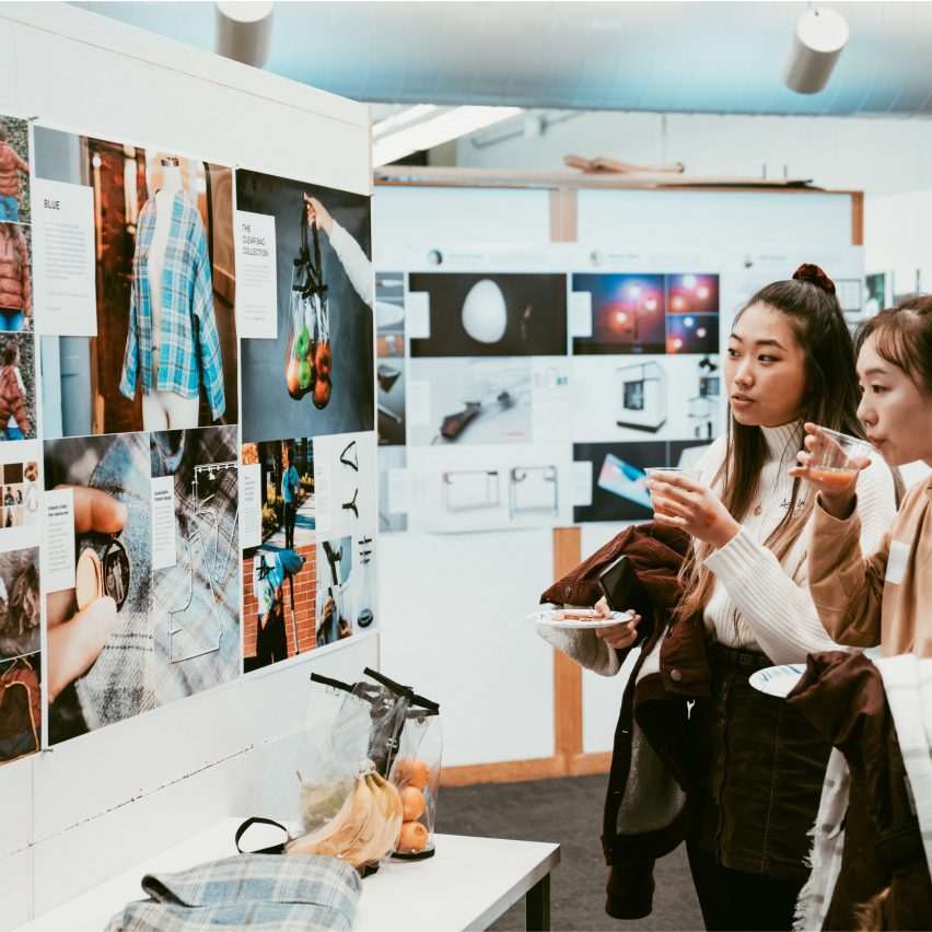 students looking at work displayed on a wall