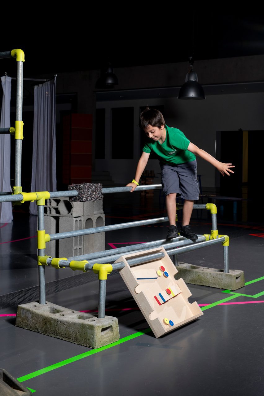 a photograph of a child walking along scaffolding