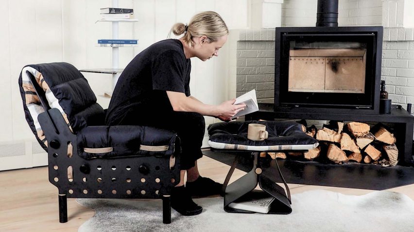 a photograph of a person sat by a fireplace