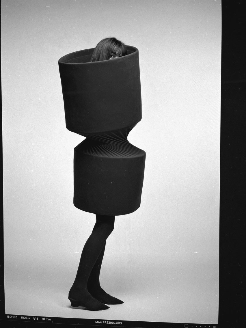 a photograph of a person wearing a black garment