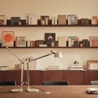 Neutral workspace with brown shelving and cupboards and metal adjustable desk lamps