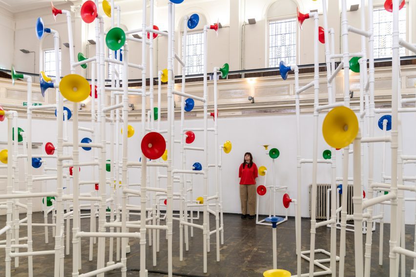 Woman standing in middle of sound installation