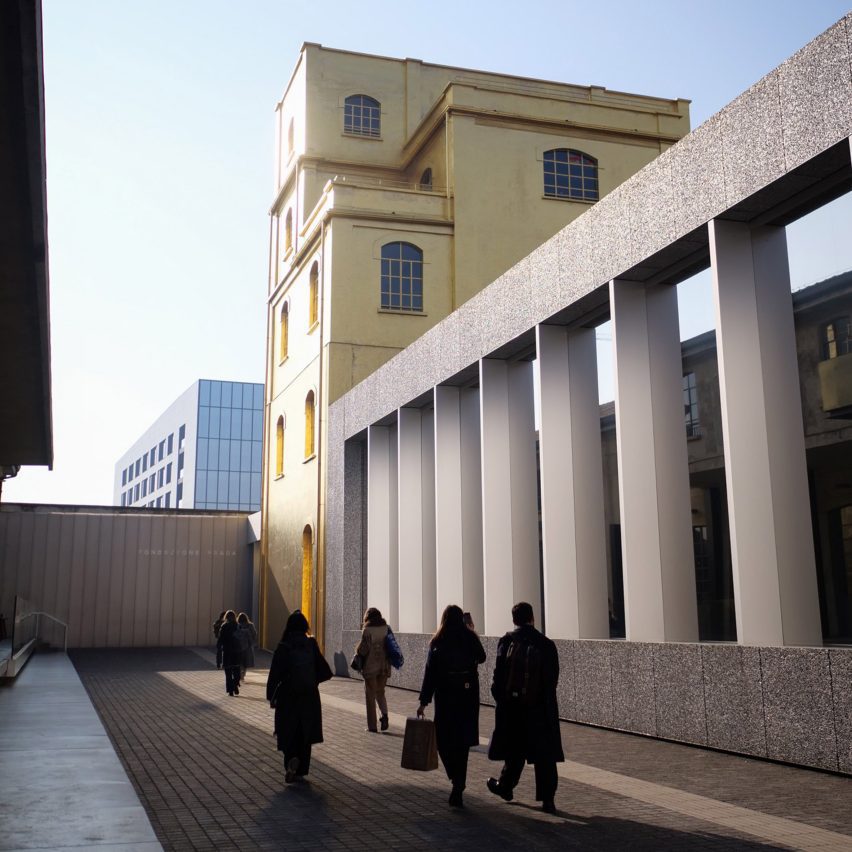 an image of a group of people walking past a building