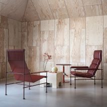Photo of red leather chairs, a wooden, cube-shaped coffee tables and a red metal side table
