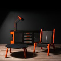 Photo of black and orange furniture: a coffee table, chair, lamp and console table