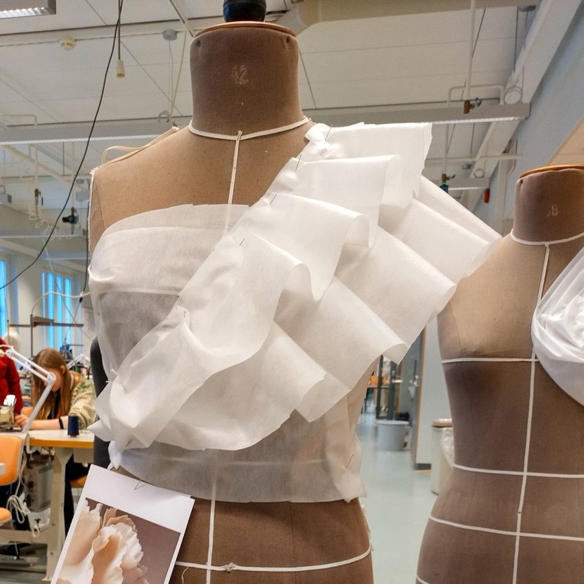 a photograph of fabric draping on mannequins