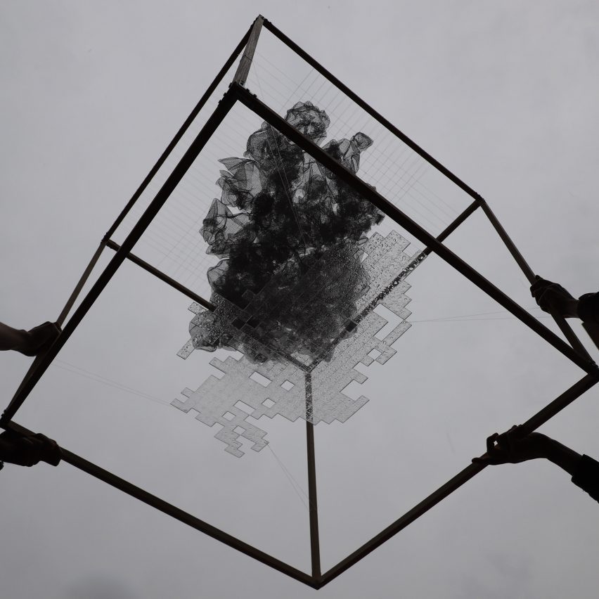 a black structure against a grey backdrop